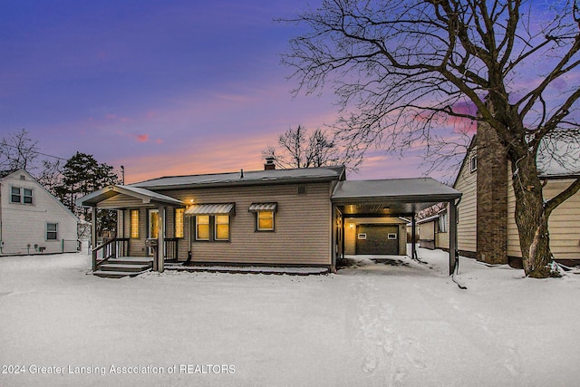 view of snow covered rear of property