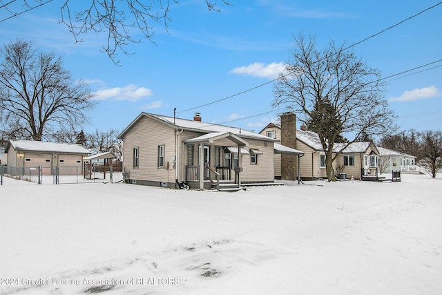 view of snow covered back of property