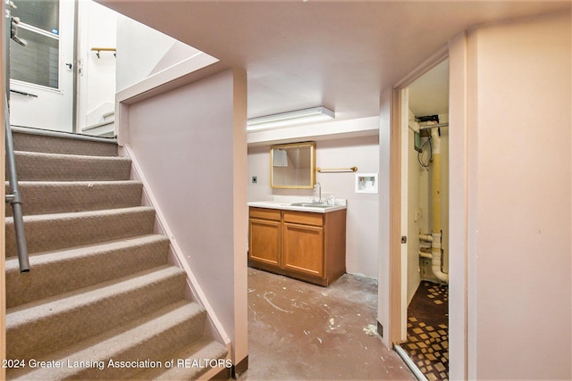 stairway with concrete flooring and sink