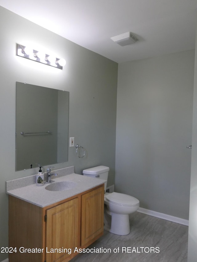 bathroom with vanity and toilet