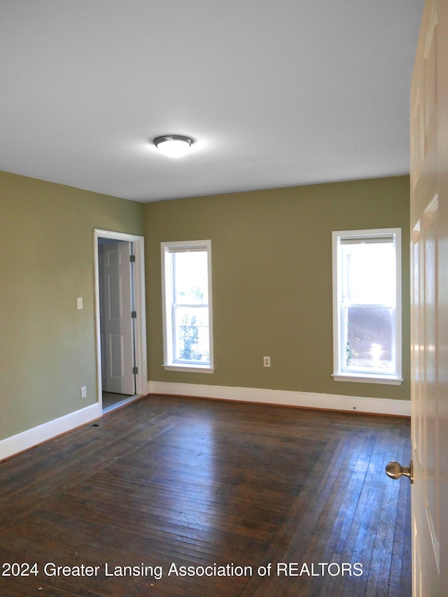 spare room with dark hardwood / wood-style flooring