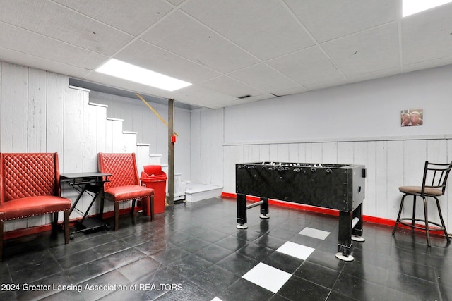 game room featuring a paneled ceiling