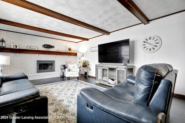 living room with hardwood / wood-style floors, a fireplace, ornamental molding, brick wall, and beamed ceiling