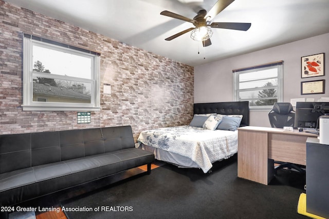 bedroom with brick wall and ceiling fan