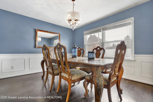 dining room featuring dark wood-type flooring and a notable chandelier