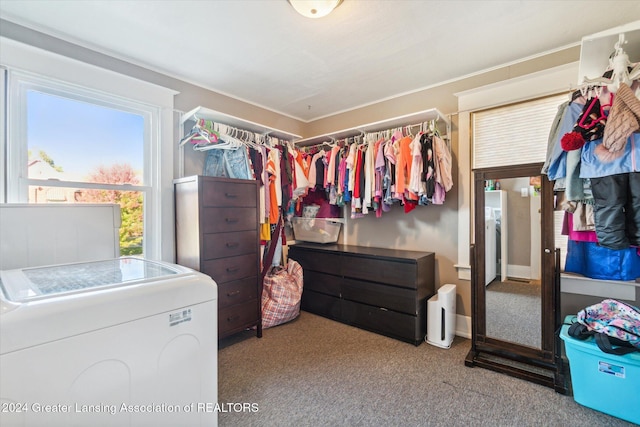 walk in closet with washer / dryer and carpet floors