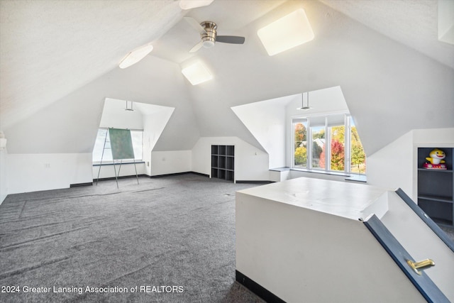 bonus room featuring a wealth of natural light, ceiling fan, carpet floors, and vaulted ceiling