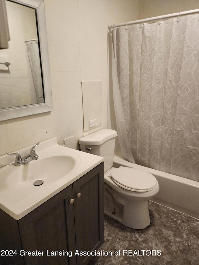 full bathroom featuring shower / tub combo, vanity, and toilet