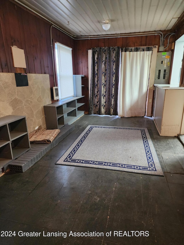 bathroom featuring electric panel and wooden walls