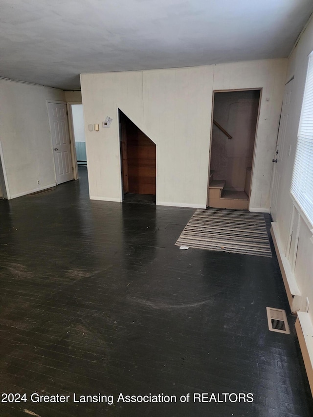 empty room featuring dark hardwood / wood-style flooring