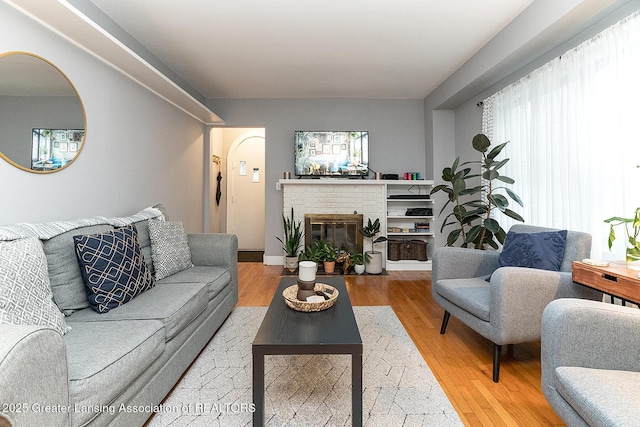 living room with plenty of natural light, hardwood / wood-style floors, and a fireplace