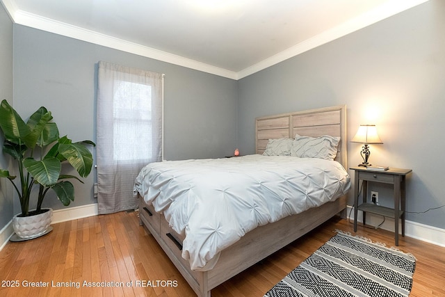 bedroom with crown molding and wood-type flooring