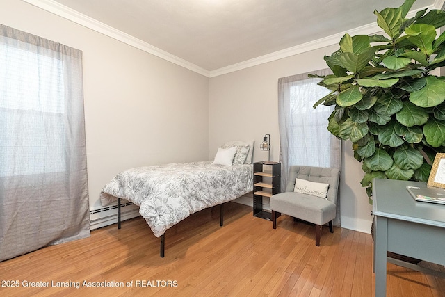 bedroom with a baseboard radiator, wood-type flooring, and crown molding