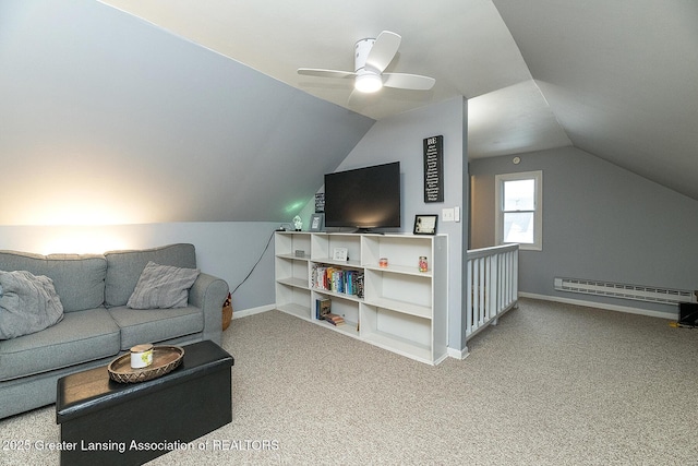 carpeted living room with ceiling fan, vaulted ceiling, and a baseboard heating unit