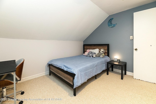 bedroom with lofted ceiling and light carpet