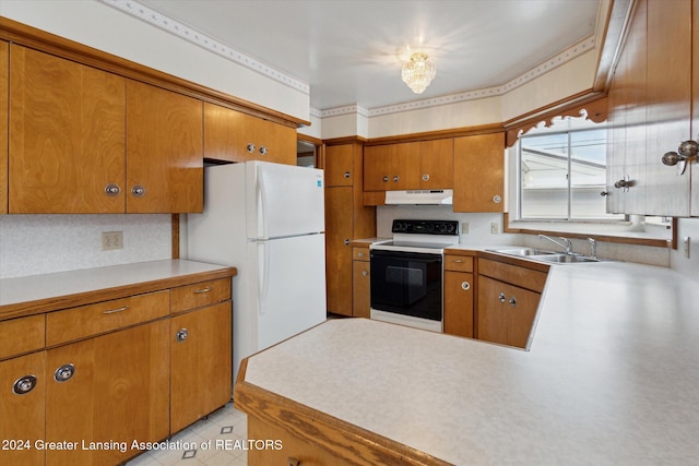 kitchen featuring white appliances, backsplash, and sink