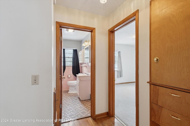 hallway featuring light wood-type flooring and sink