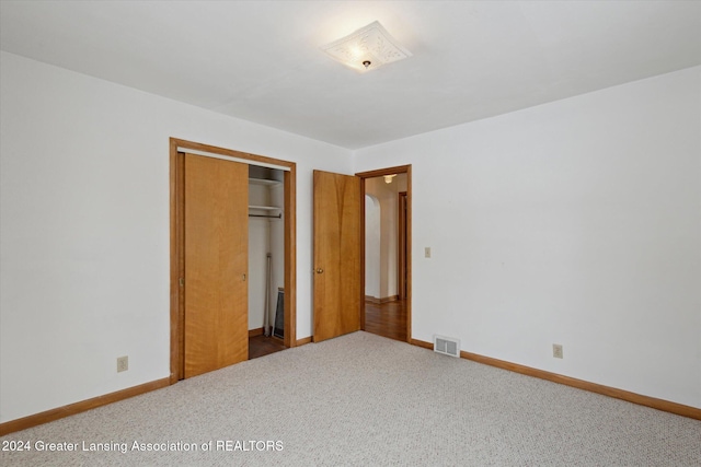 unfurnished bedroom with carpet and a closet