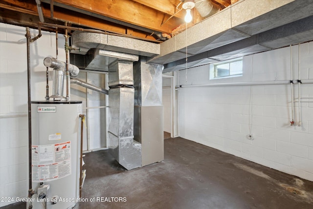 basement featuring heating unit and water heater