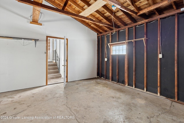 interior space with lofted ceiling with beams, wood ceiling, and concrete floors