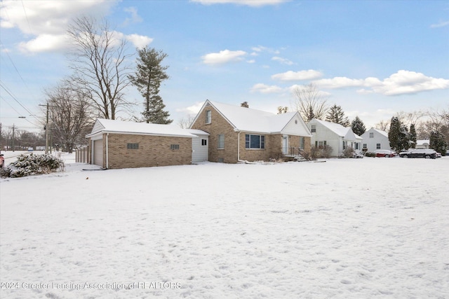 snow covered property featuring a garage