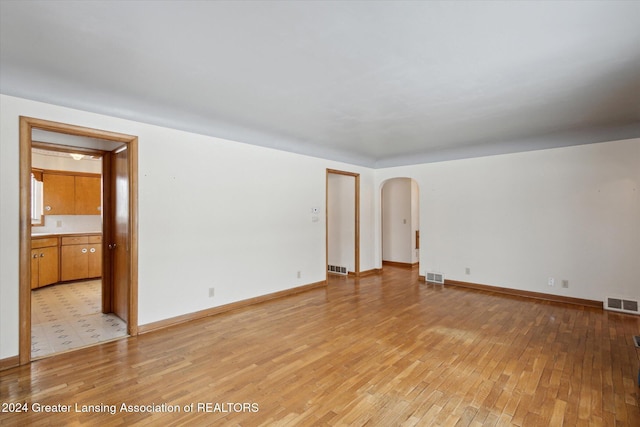 empty room with light hardwood / wood-style flooring