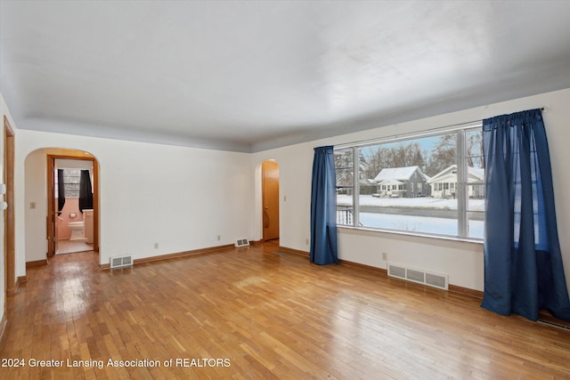 empty room with hardwood / wood-style flooring