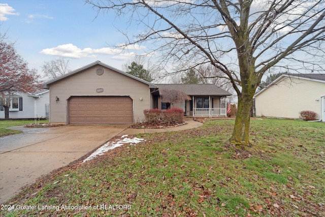 single story home featuring a porch, a front lawn, and a garage