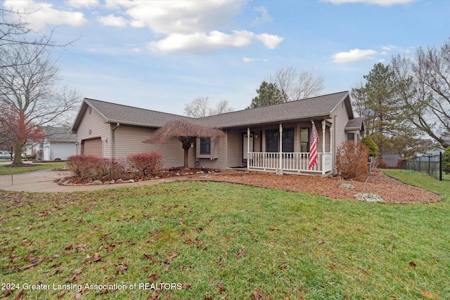 ranch-style home featuring a garage, covered porch, and a front lawn