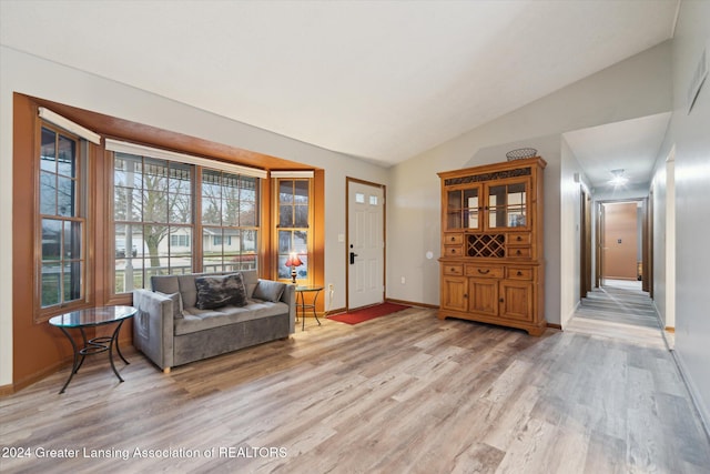 sitting room with light hardwood / wood-style floors and vaulted ceiling