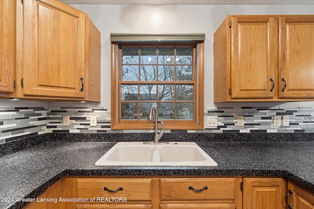 kitchen featuring tasteful backsplash and sink