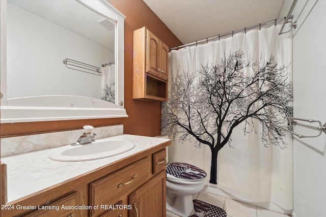 bathroom featuring tile patterned floors, vanity, and toilet