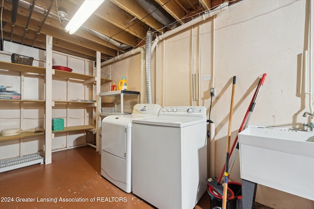 clothes washing area with sink and washing machine and dryer