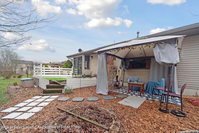 rear view of property featuring a gazebo