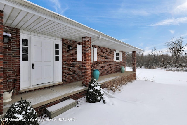 view of snow covered property entrance