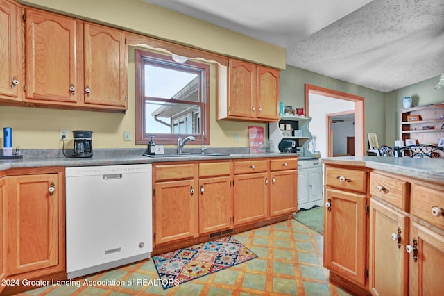 kitchen with sink, white dishwasher, and a textured ceiling