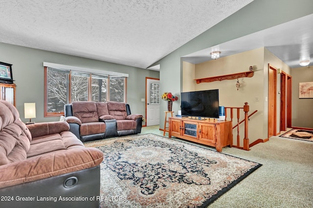 living room with carpet, lofted ceiling, and a textured ceiling