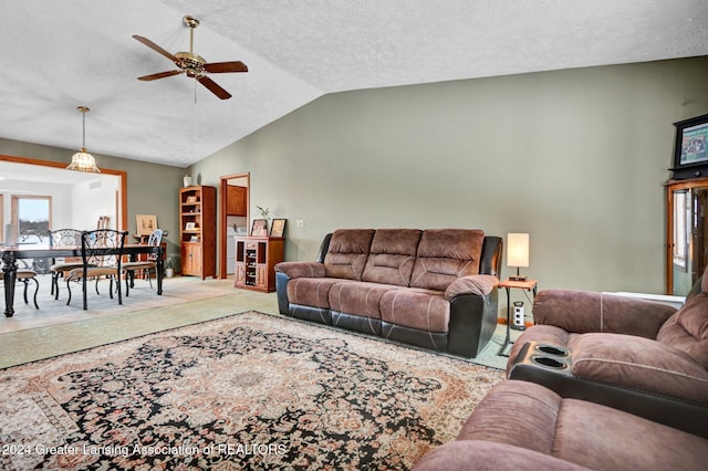 carpeted living room with a textured ceiling, ceiling fan, and lofted ceiling