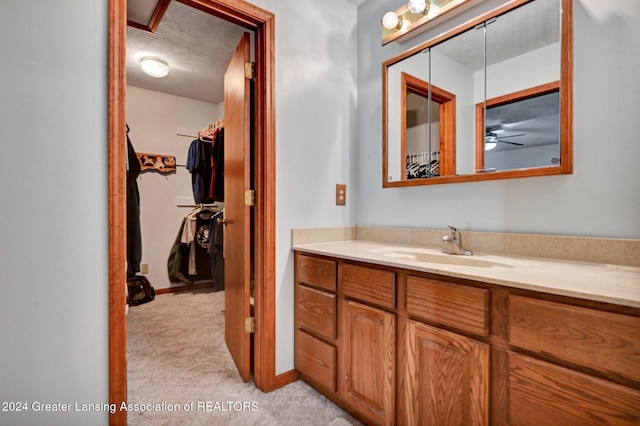 bathroom featuring vanity, a textured ceiling, and ceiling fan