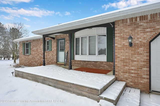 view of snow covered property entrance