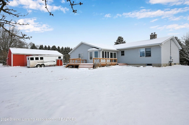 view of front of house featuring an outdoor structure and a deck