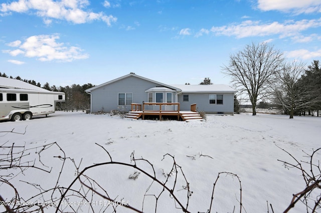 snow covered property featuring a deck