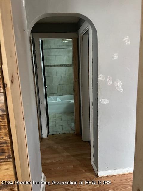 hallway with hardwood / wood-style floors