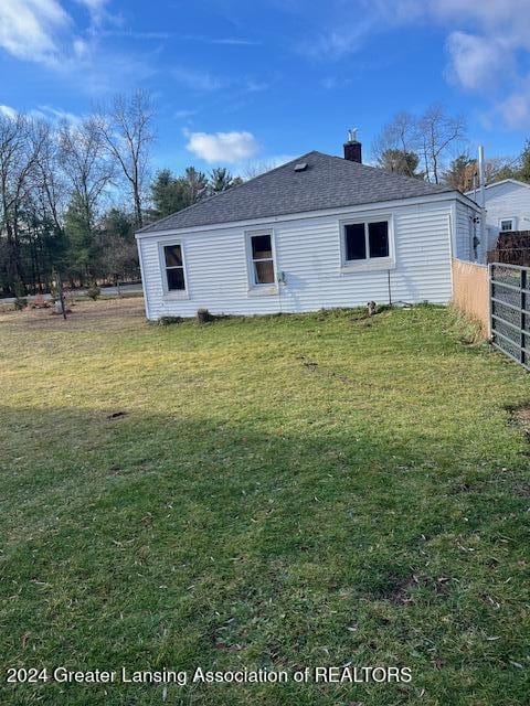 rear view of property with a yard