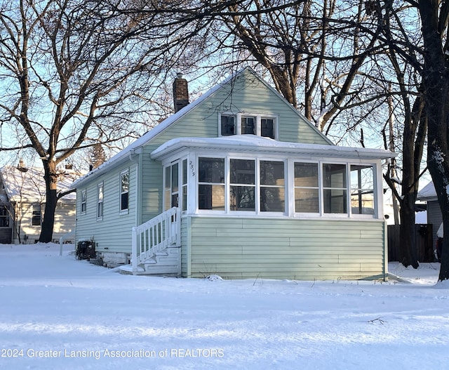 bungalow-style home with a sunroom