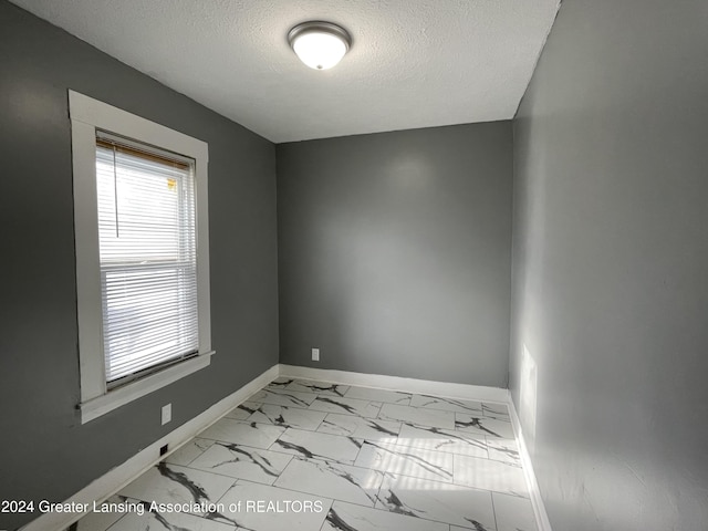 empty room with a textured ceiling