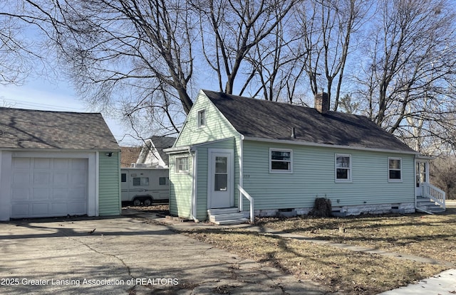 view of front of house featuring entry steps, a chimney, driveway, and crawl space