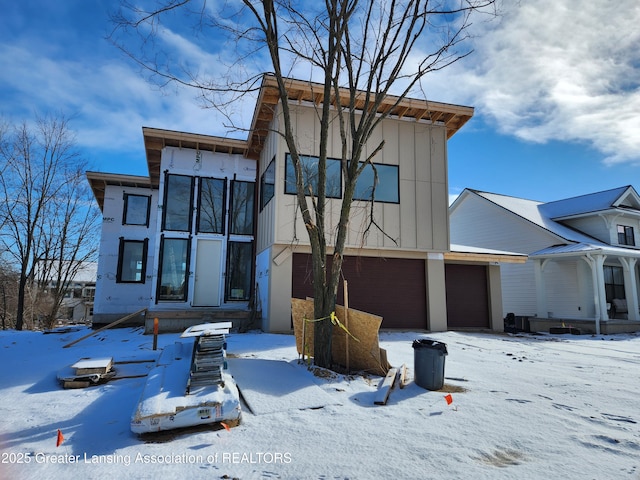 modern home with a garage and board and batten siding