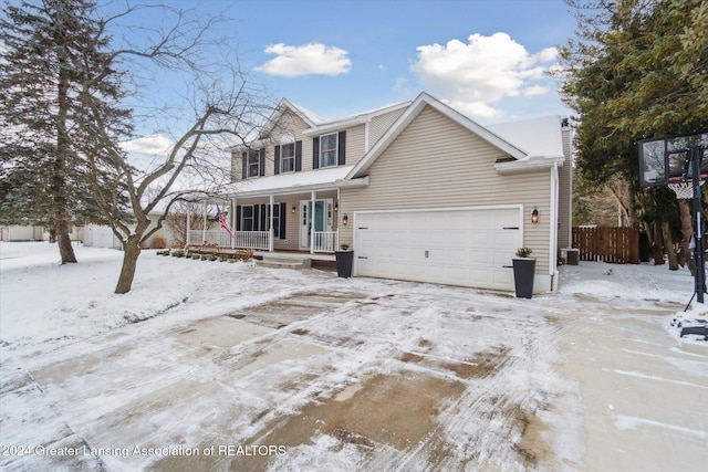 view of property featuring cooling unit, covered porch, and a garage