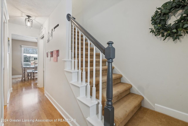 stairs featuring hardwood / wood-style flooring